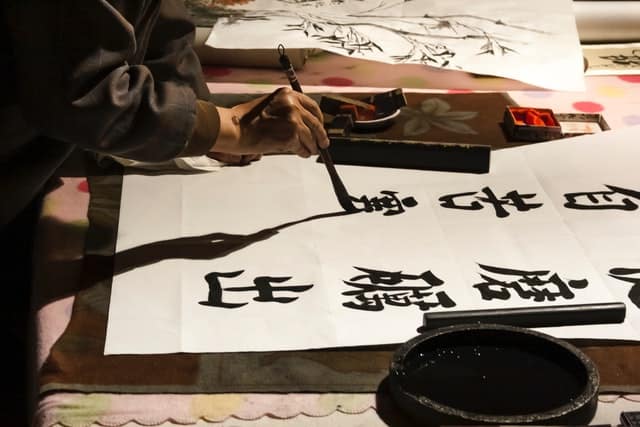 A man writing Chinese characters