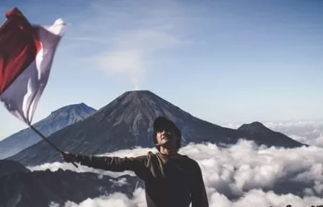man waving indonesian flag