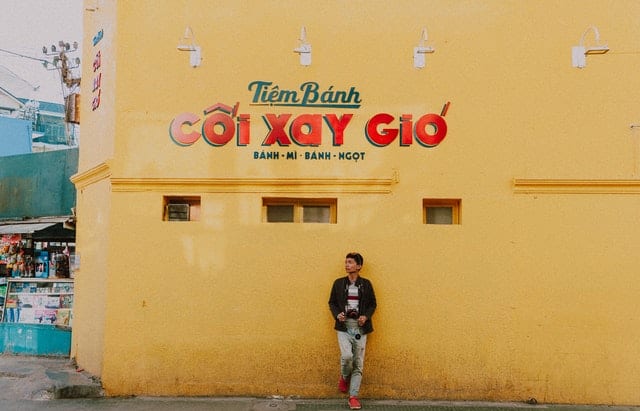 man learning on building with vietnamese writing
