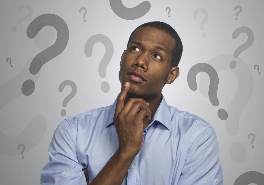 Man thinking with questions marks in the background