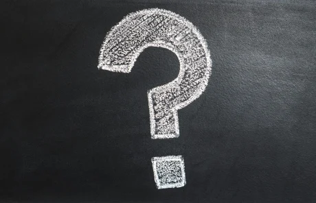 A white question mark on a black background