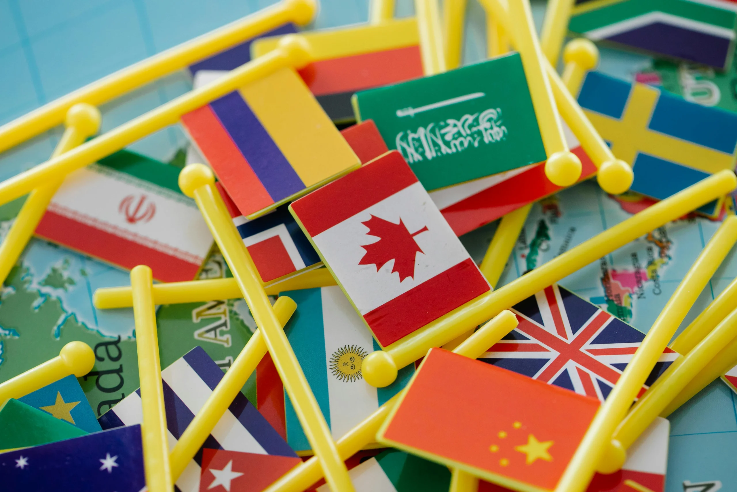 This image shows various toy flags laying over a map.